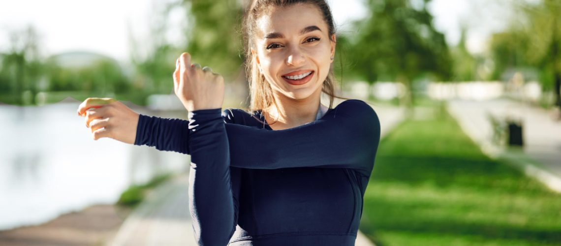 fit-young-girl-dark-blue-sportswear-exercising-park